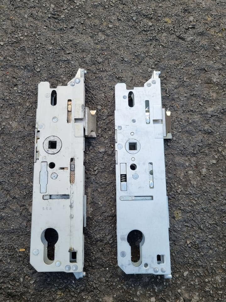 2 Fuhr upvc door locks with old faulty lock on the left with new replacement lock on the right laid on concrete 