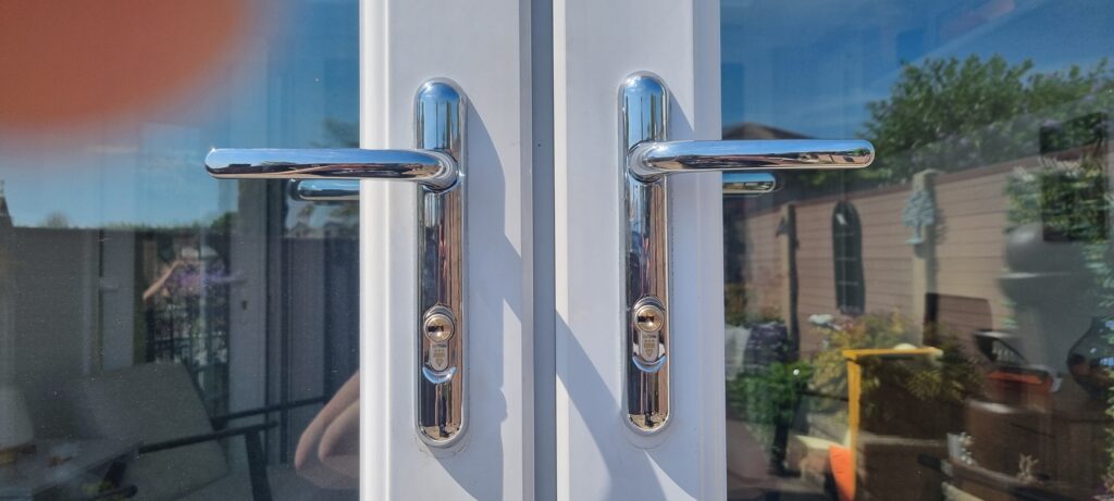 Two Brisant Ultion high security locks fittted tto white patio doors in Limeside with chrome door handles 