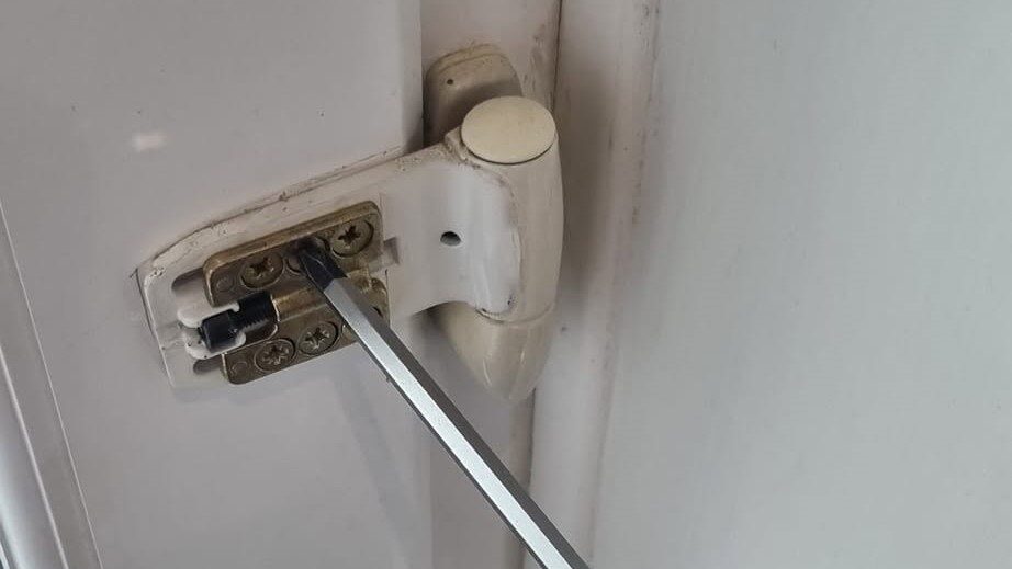 white upvc door hinge repaired and adjusted with screwdriver turning adjusters